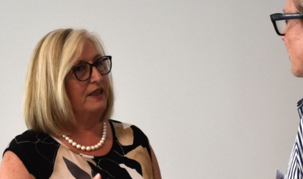 Woman in glasses talking to another woman in glasses