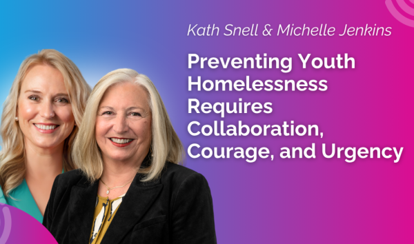 Katie Snell and Michelle Jenkins smiling on banner