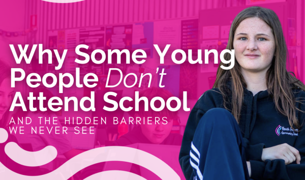Photo of girls looking at the camera in front of pink banner